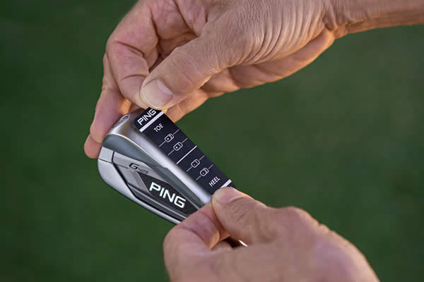 Fitter applying impact tape to bottom of iron