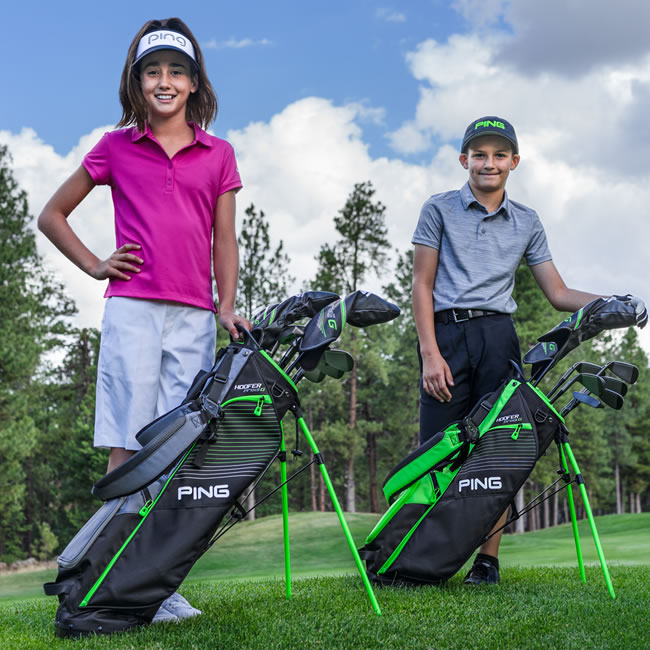 Two junior golfers standing with Prodi G sets